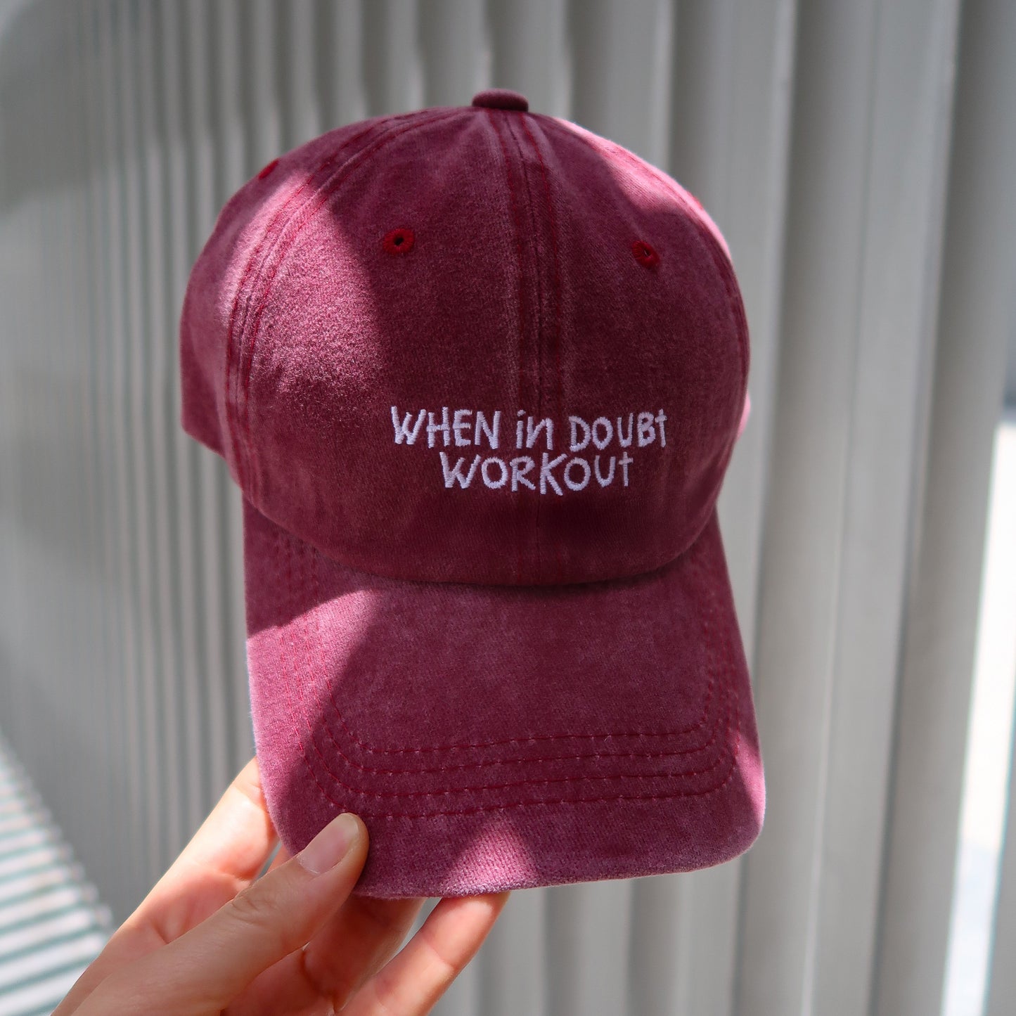 Maroon cap with 'When in doubt, workout' text 